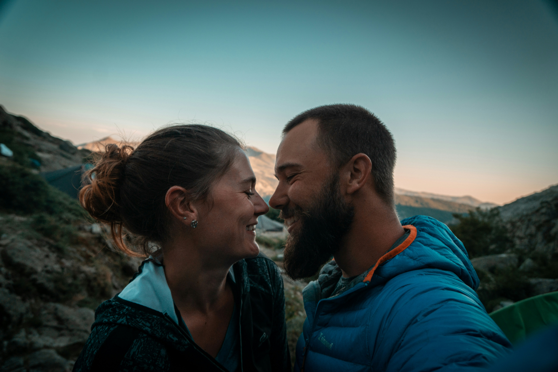 A couple sitting together in warm light having a meaningful, mindful conversation — representing healthy communication and emotional connection in relationships