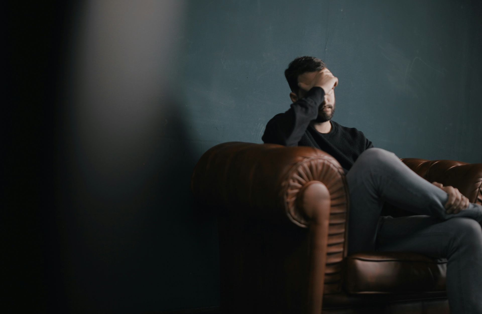 A thoughtful person sitting quietly by a window — representing emotional distance and the longing for deeper connection in a relationship